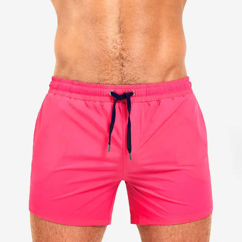 Men's solid colour mesh lining polyester sports shorts for swimming and fitness.
