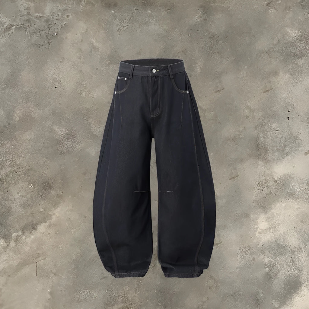 Men's original cow colour wide leg denim trousers laid flat showing mid-waist and relaxed leg cut