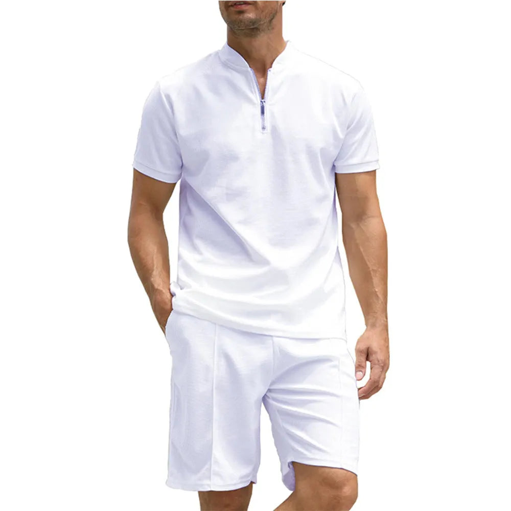 Man wearing a solid colour polo shirt and matching trousers from a two-piece set in beaded bird's eye polyester fabric.