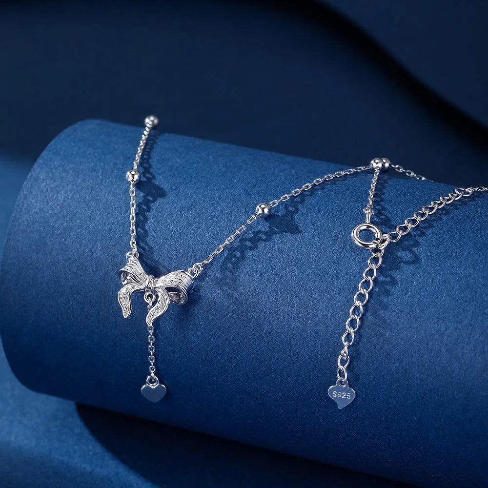 925 sterling silver necklace with a detailed butterfly and heart-shaped pendant on an adjustable O-ring chain.
