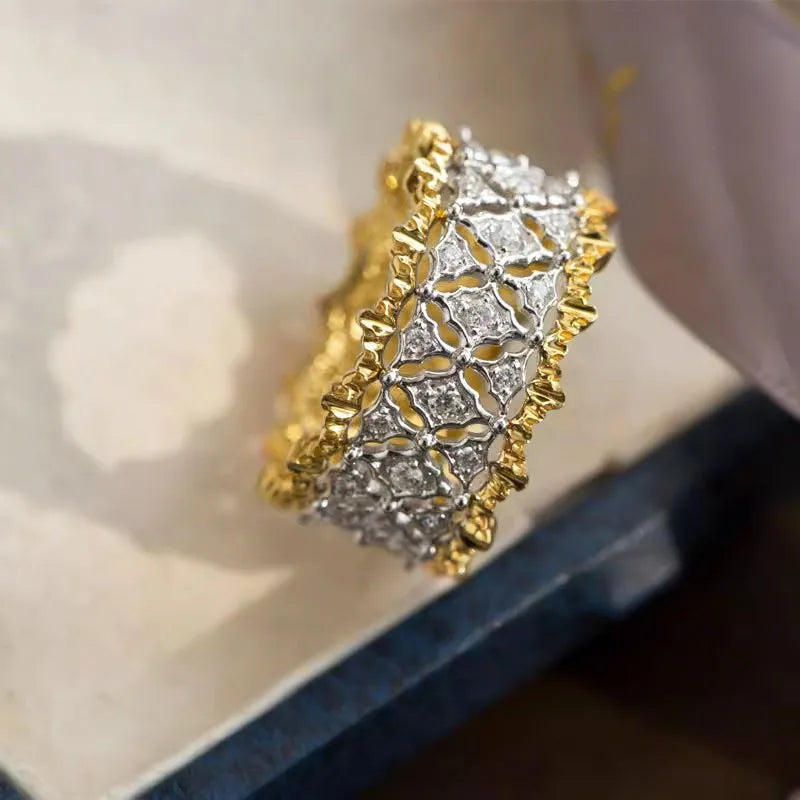 A geometric two-tone zircon ring with a gold-colour electroplated copper finish and round details.