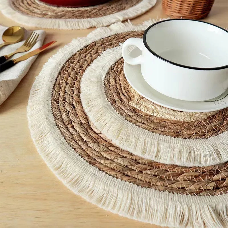 Japanese straw round placemat with tassel trim in natural papyrus material on dining table