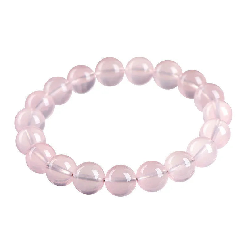 Pink crystal bracelet with round polished beads in natural starlight style showing size options from 6mm to 22mm diameter