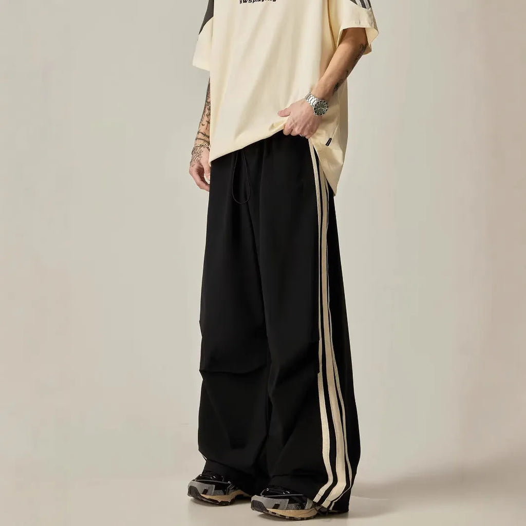 Man wearing black high-waisted straight-leg casual climbing trousers.