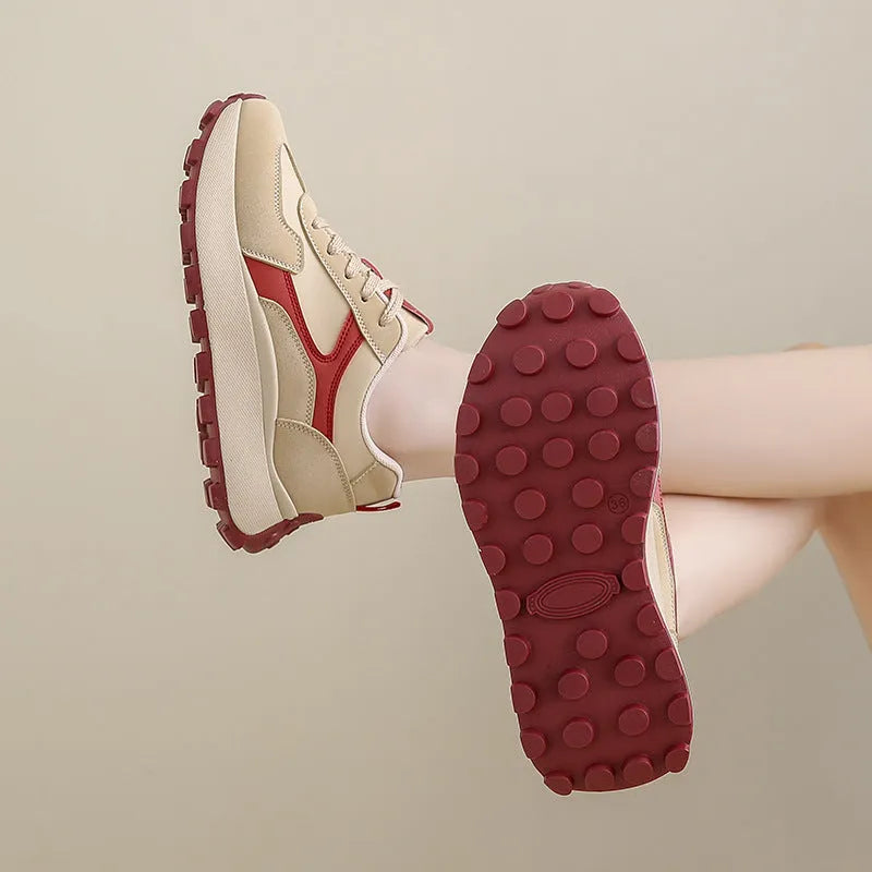 Women's low-top platform running shoes in black, red, or grey with lace-up front and flat rubber sole.