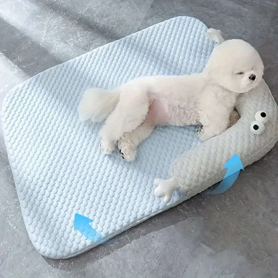 Blue pet cushion with large monster face design for dogs and cats on a wooden floor.