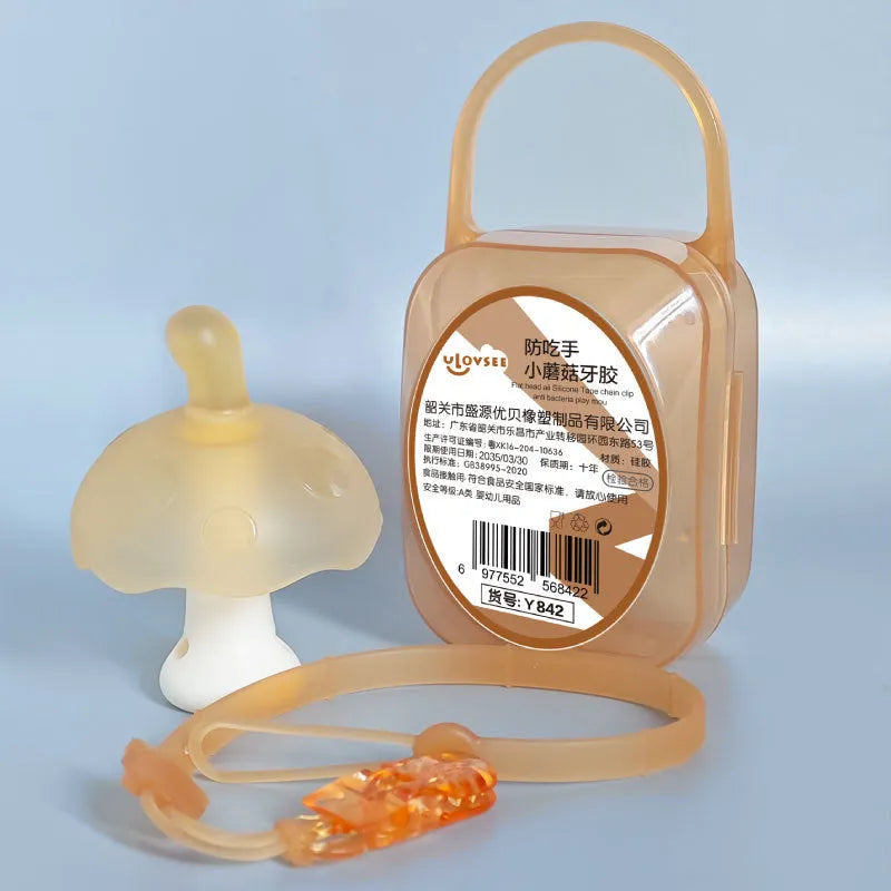 Small mushroom-shaped silicone chewing gum on a chain, in pink or nano colour, inside a transparent box.