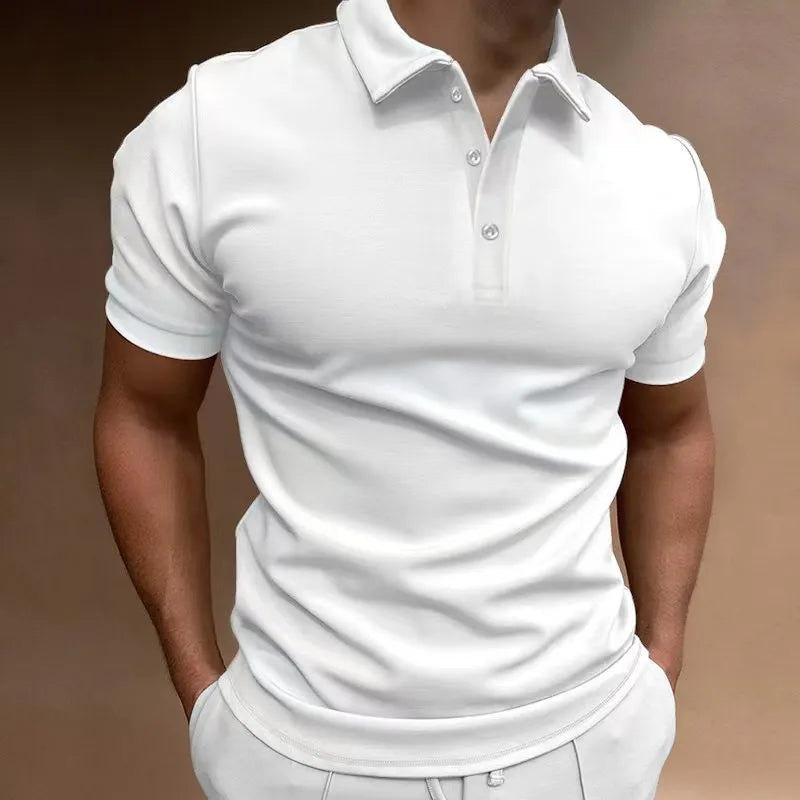 Man wearing a loose fit grey cotton blend T-shirt with a button-down front and short sleeves.