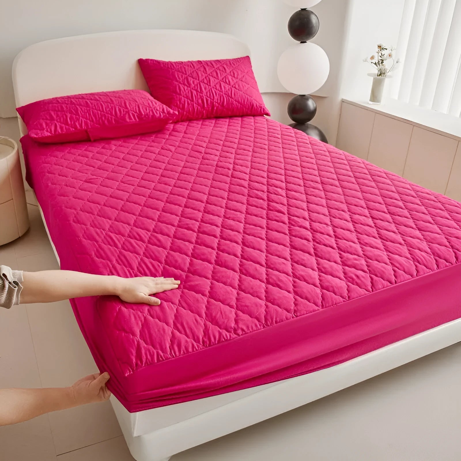 Diamond lattice quilted waterproof mattress protector and pillowcases in a solid colour.