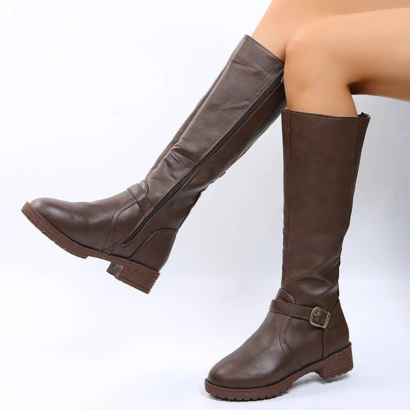 Women's yellow knight high boots with buckle details on shaft and a square heel.