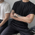 Men's slim fit cotton t-shirt in solid white or black with half sleeves and round neck