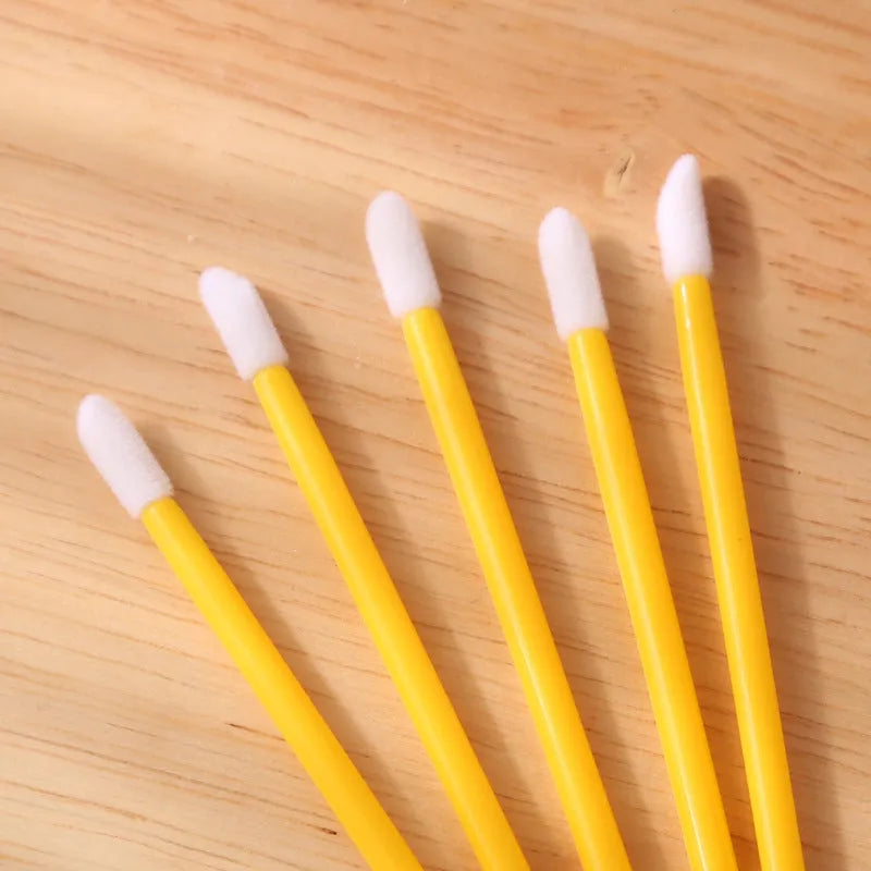 Disposable lip brushes with coloured handles and flocked brush heads for lip makeup application