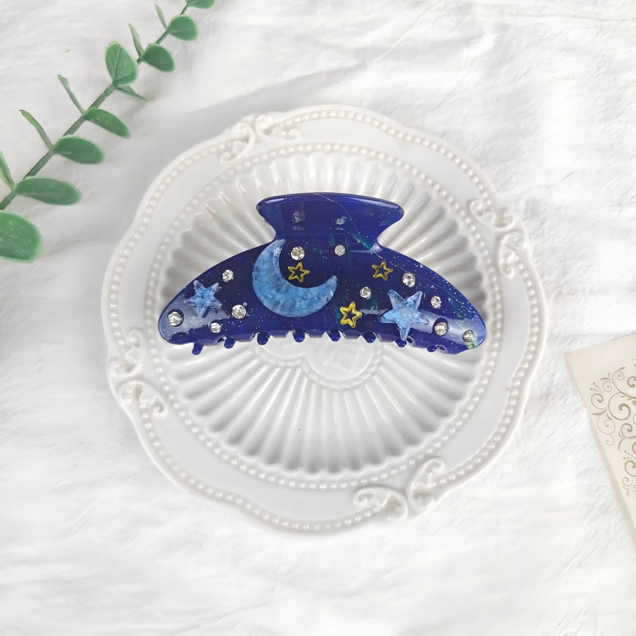 Oversized women's barrette with star moon starry sky pattern in sky blue colour.