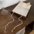 Gold women's hairpin with pearl flower decoration and long tassel detail