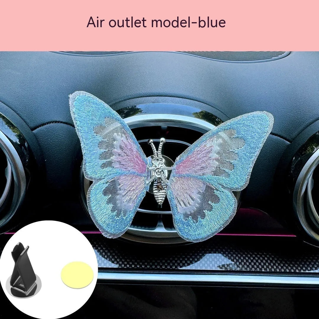 Moving embroidery butterfly decoration on car centre console air vent in pink fabric