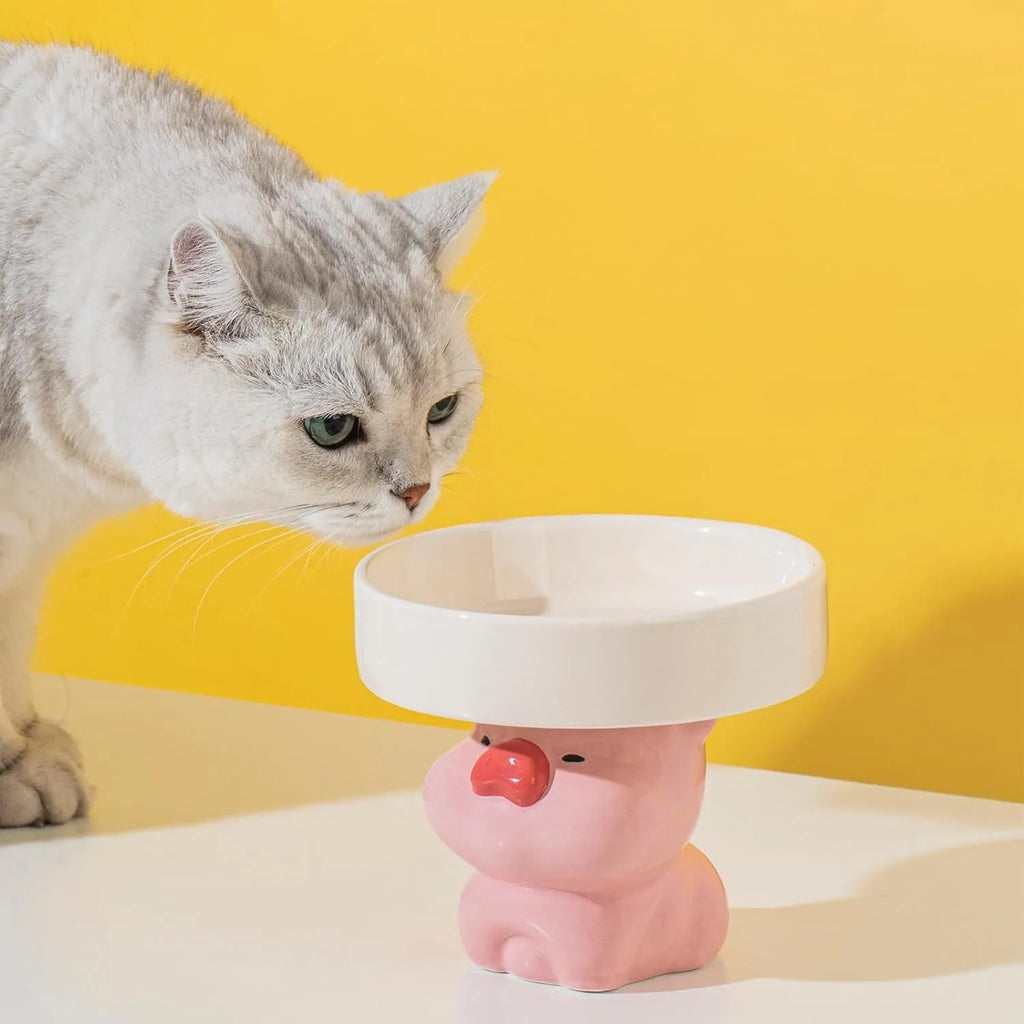 Raised ceramic cat bowl in animal design, showing elevated feeder stand and wide food bowl opening.