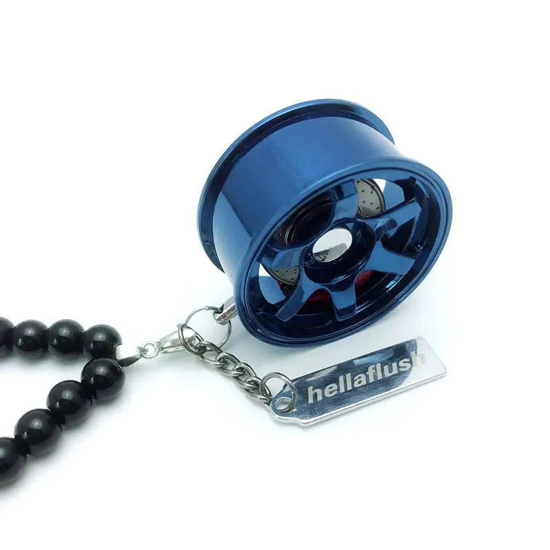 Stainless steel car tyre ornament with crystal glass bead chain hanging from a rearview mirror