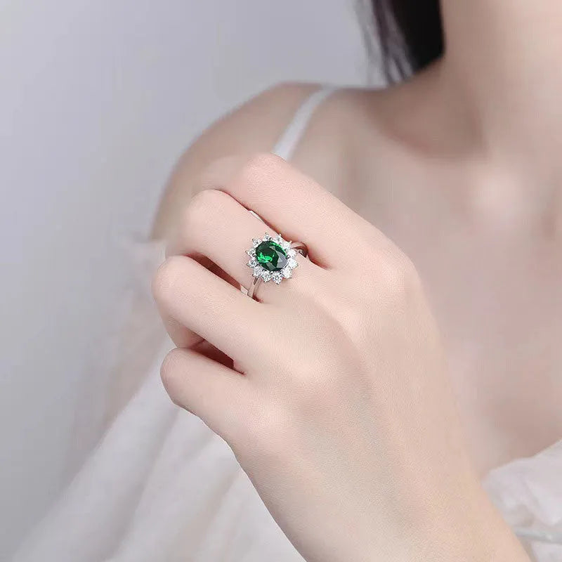 Copper women's ring with floral band and inlaid blue zirconium stone, shown on a finger.