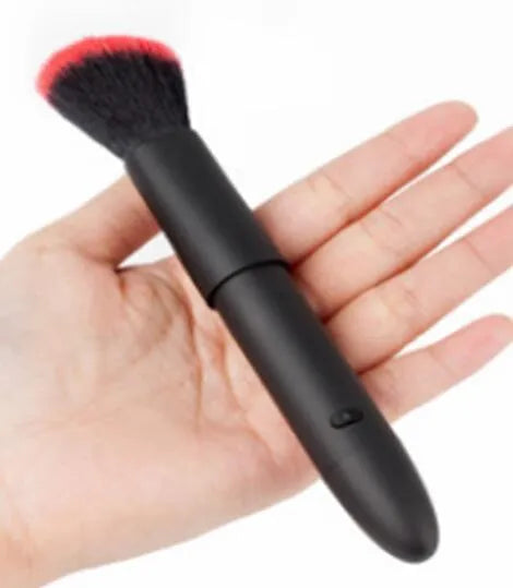 Women's beauty vibrator cosmetics brush massage toy in black with USB recharge port and one-button control