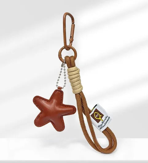 Handmade resin handbag pendant with soda bread designs including cartoon croissant and brown stars