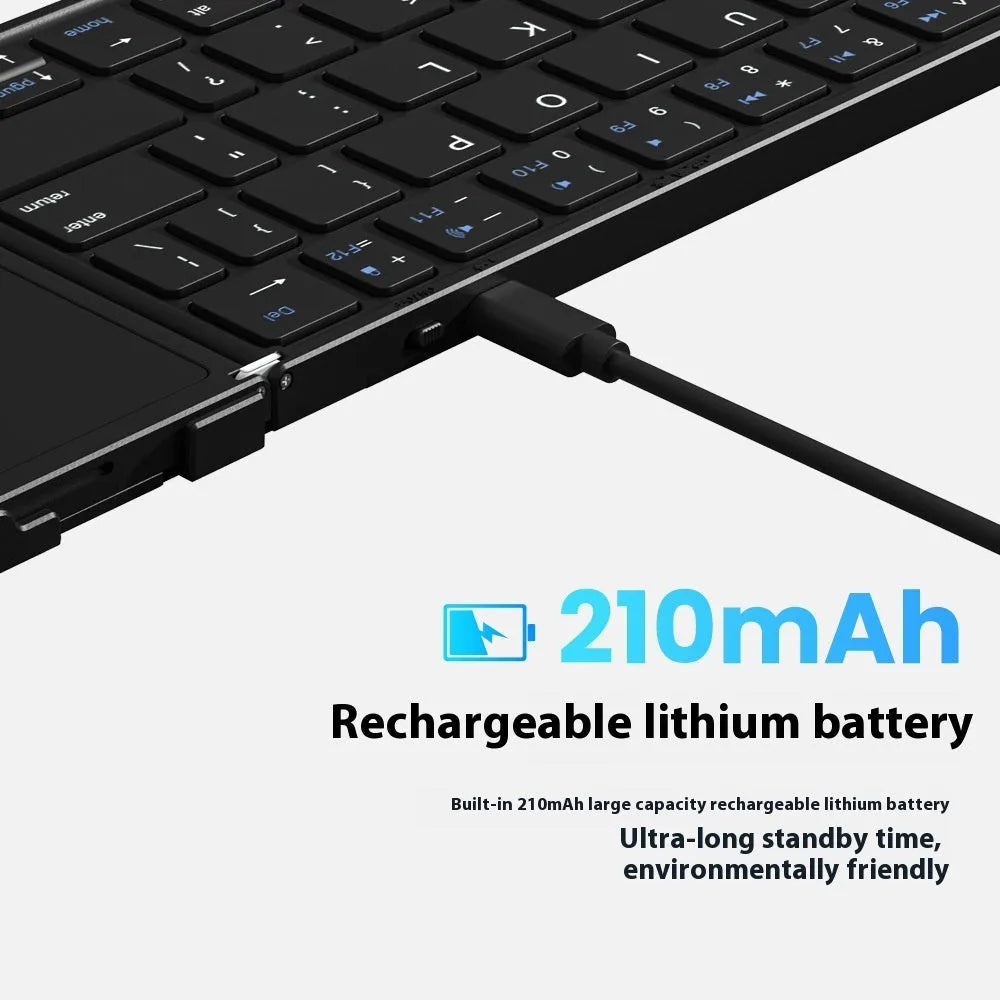 Black folding Bluetooth keyboard with touchpad option next to a mobile phone