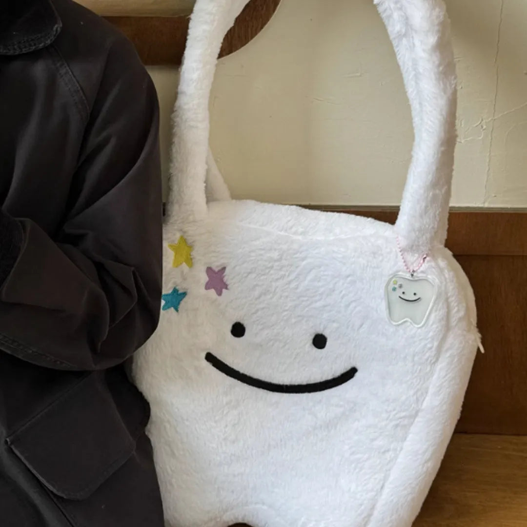 White plush shoulder tote bag with large tooth pattern decoration and zipper closure
