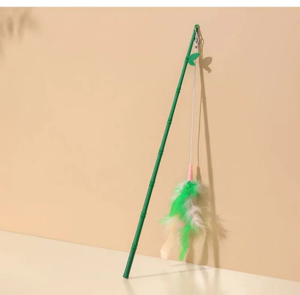 Green cat feather wand toy with bell and feather attachments for interactive play