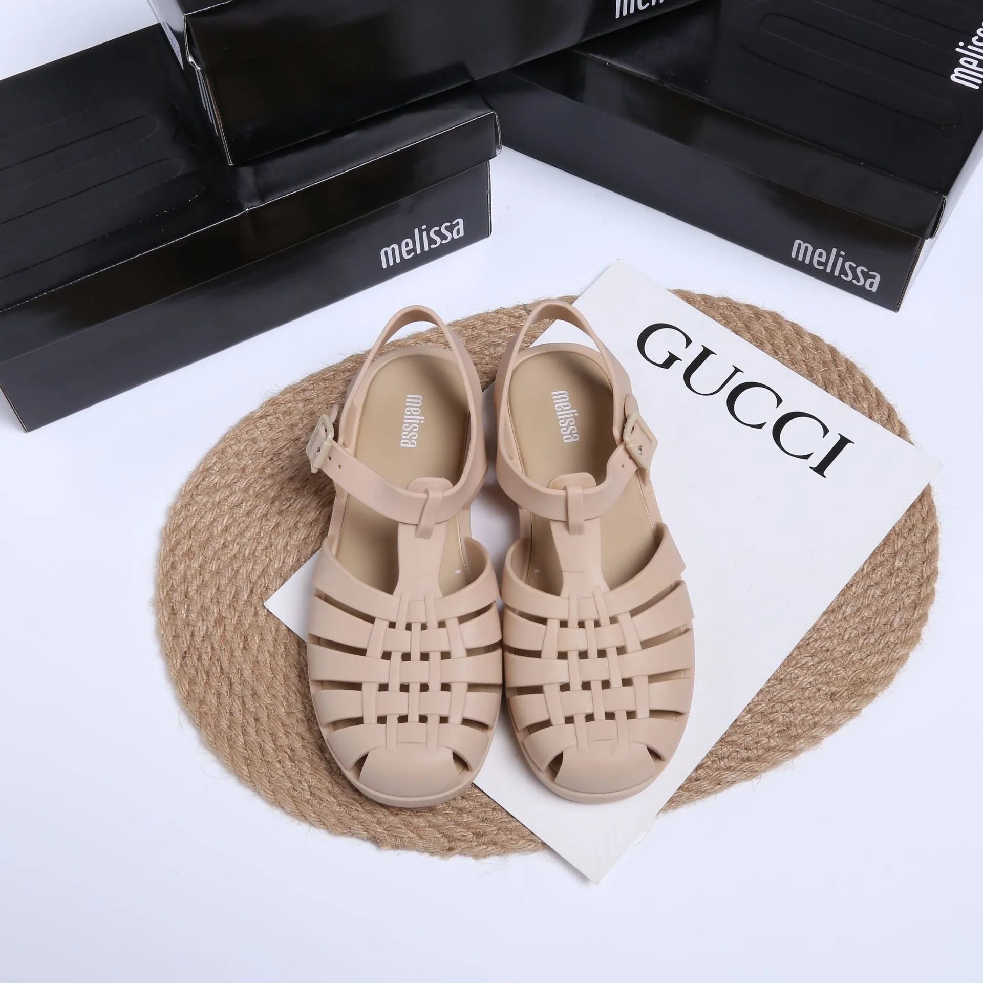 Black Roman-style sandals with buckle fastening and hollow-out design on low-top PVC upper