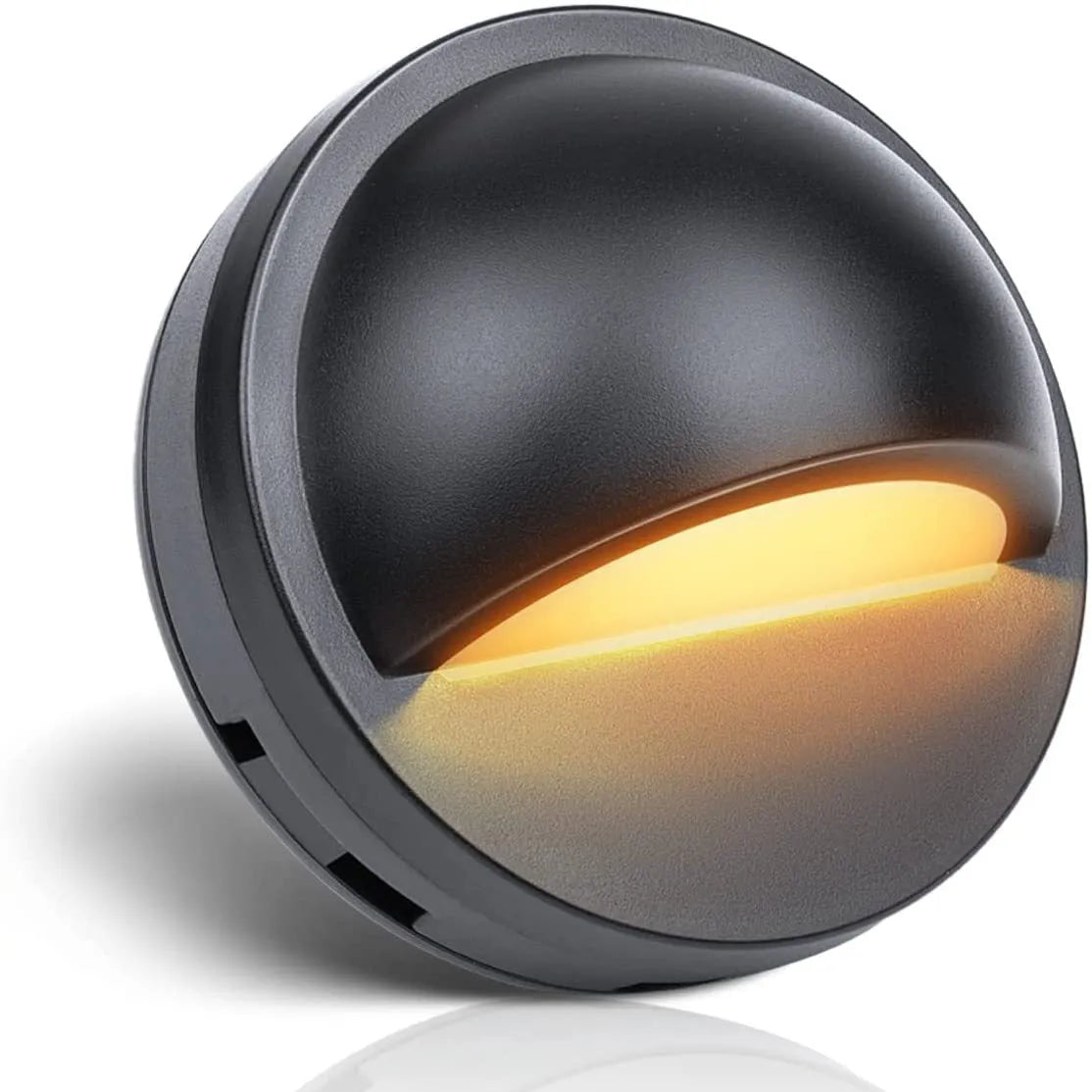 Compact outdoor low-voltage step light with aluminium and plastic housing, shown in a garden setting.