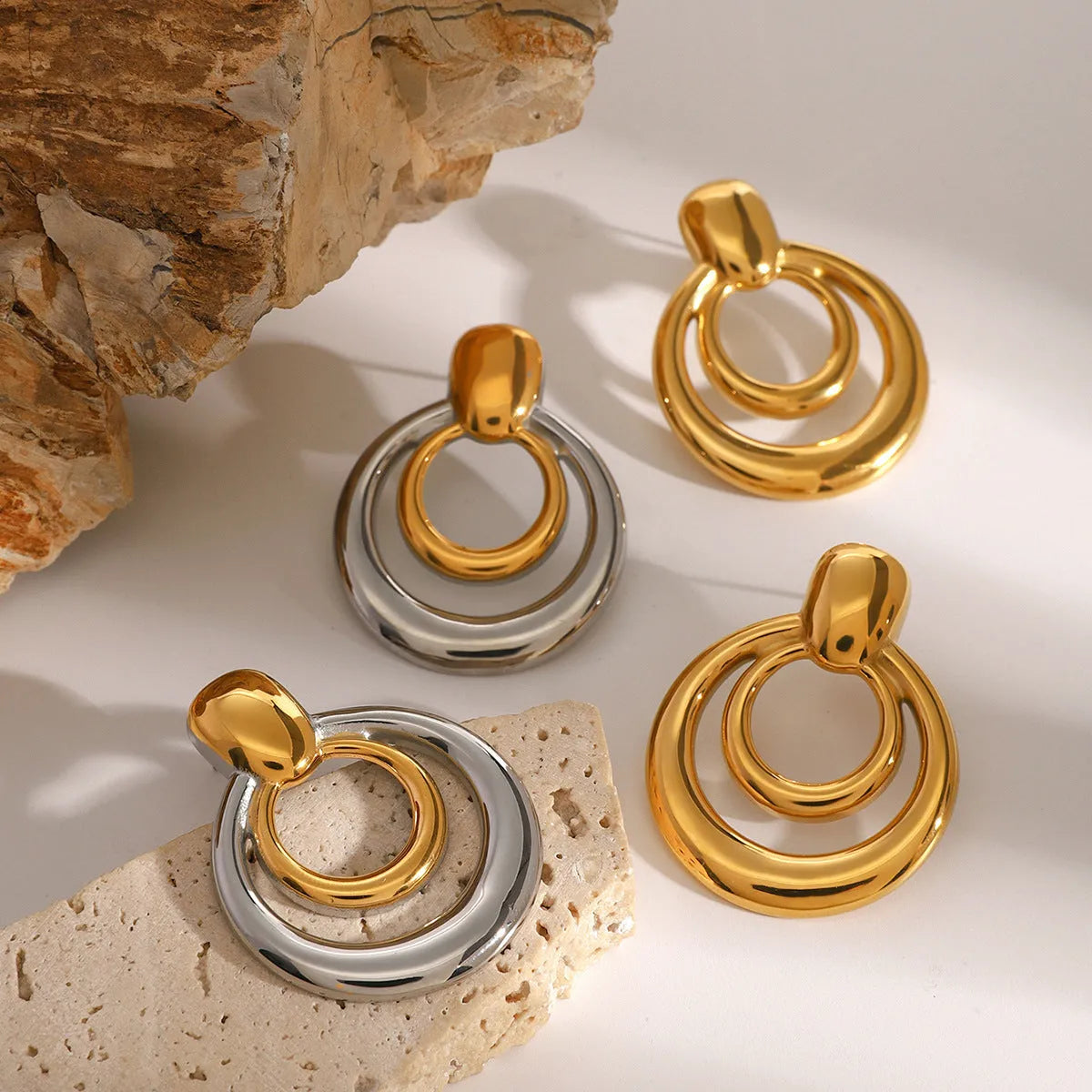 Golden round double layer hollow stud earrings with 18K gold electroplating on titanium steel