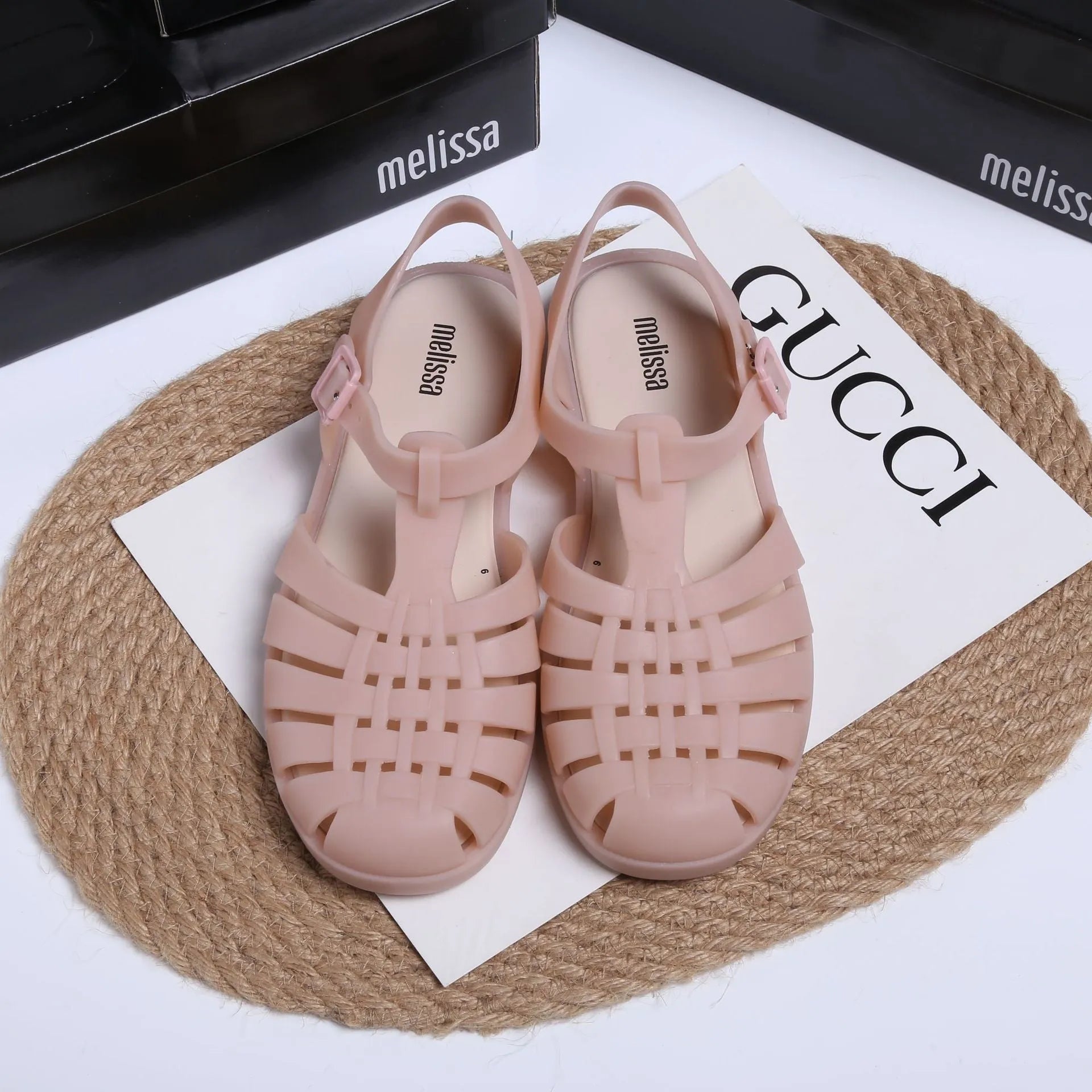 Black Roman-style sandals with buckle fastening and hollow-out design on low-top PVC upper