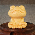 Solid bamboo carving of a cartoon smiling frog ornament, 5cm tall.
