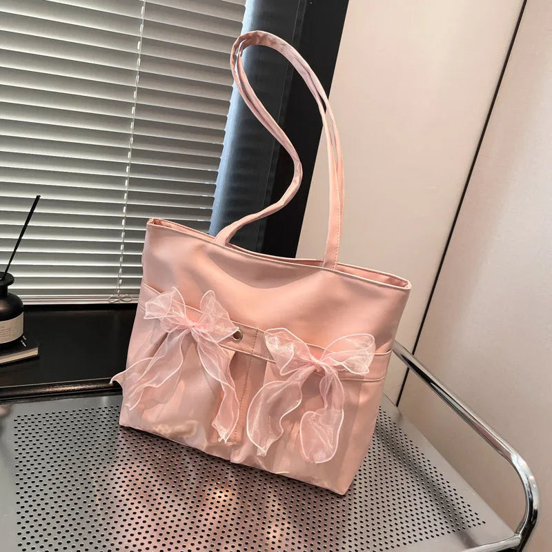 College style bow tote bag in black or pink with large capacity and internal zipper compartment