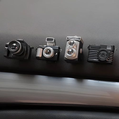 Pack of four retro camera dot design adhesive hooks for car interiors.