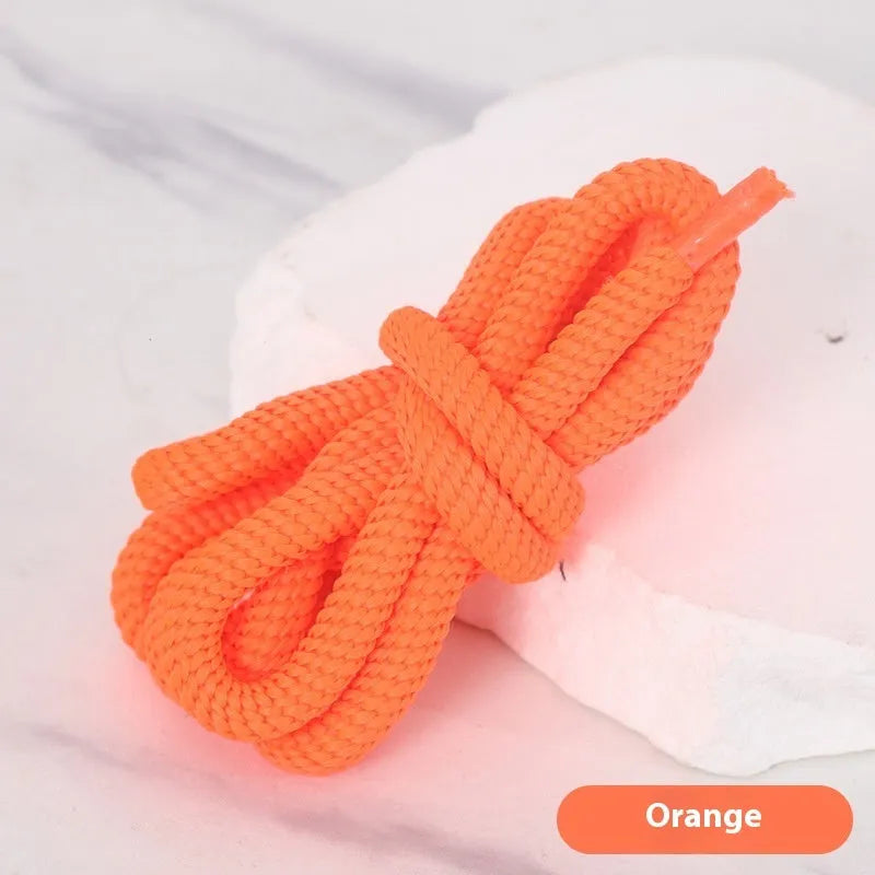 Oval cross-section shoelace adapter rope in various colours, shown next to a trainer and sweatshirt.