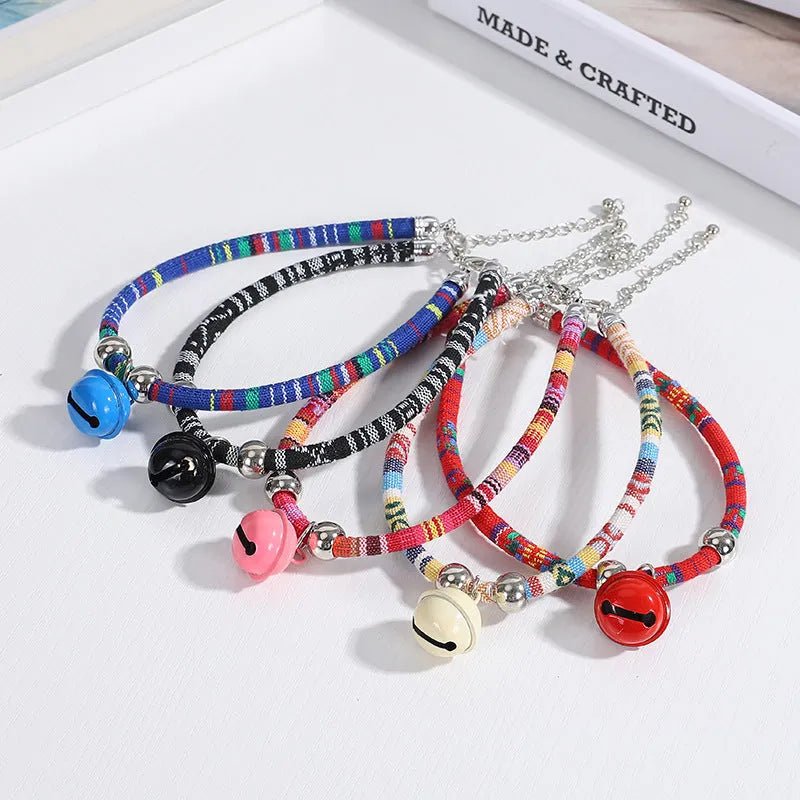 Adjustable pet collar with bell in ethnic pattern, showing colour options: black, blue, pink, red, white.