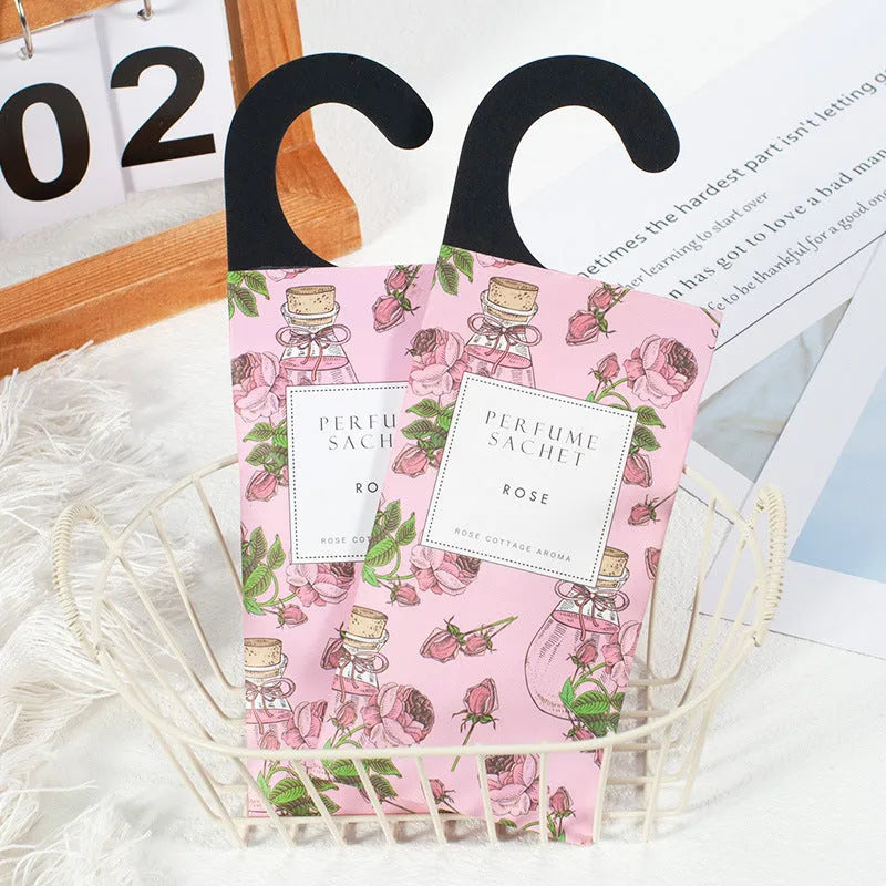 Five 30g lavender and rose scented wardrobe sachets on a shelf, each measuring 21x8cm