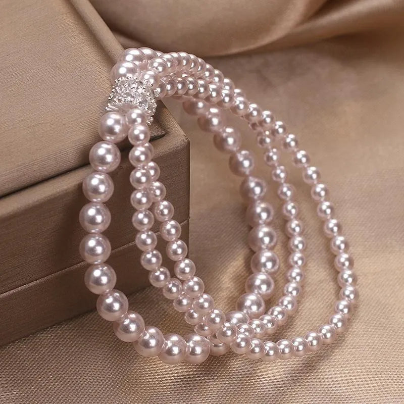 Baroque pearl multi-layer twin bracelet in white with electroplated finish on neutral background