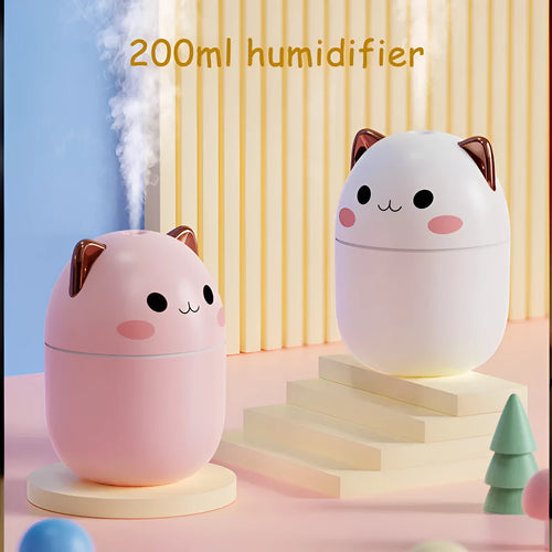 Cute cat-shaped USB air humidifier with LED cool mist spray in white, for office and bedroom use.