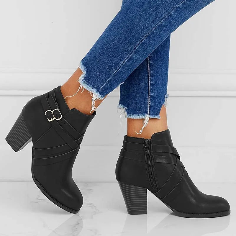 Men's black short ankle boots with side zip, belt buckle, and a 7cm heel.