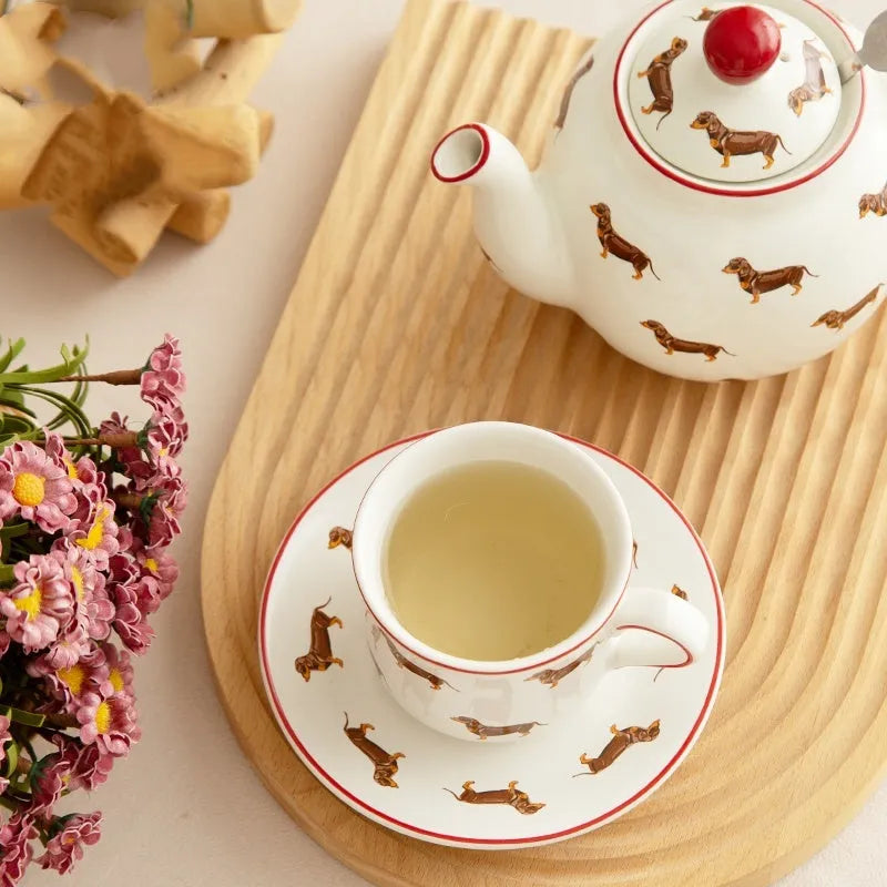 Ceramic sausage dog teapot mug cup and saucer three-piece set on table