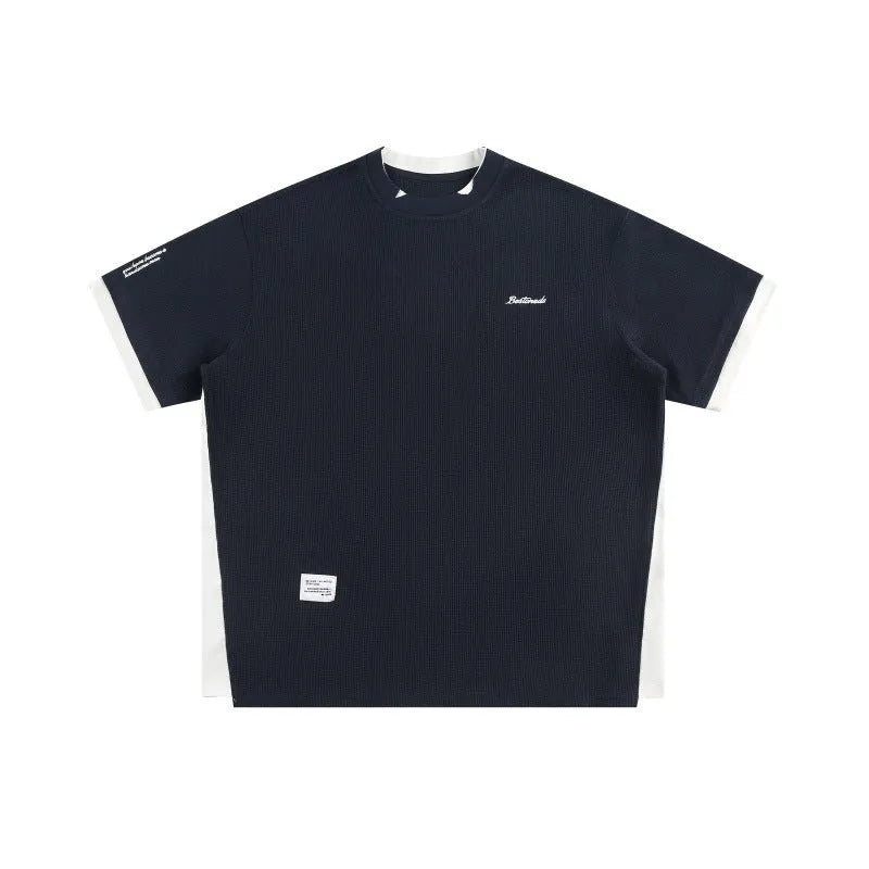 Retro alphabet embroidered loose waffle short-sleeved t-shirt in navy blue, laid flat.