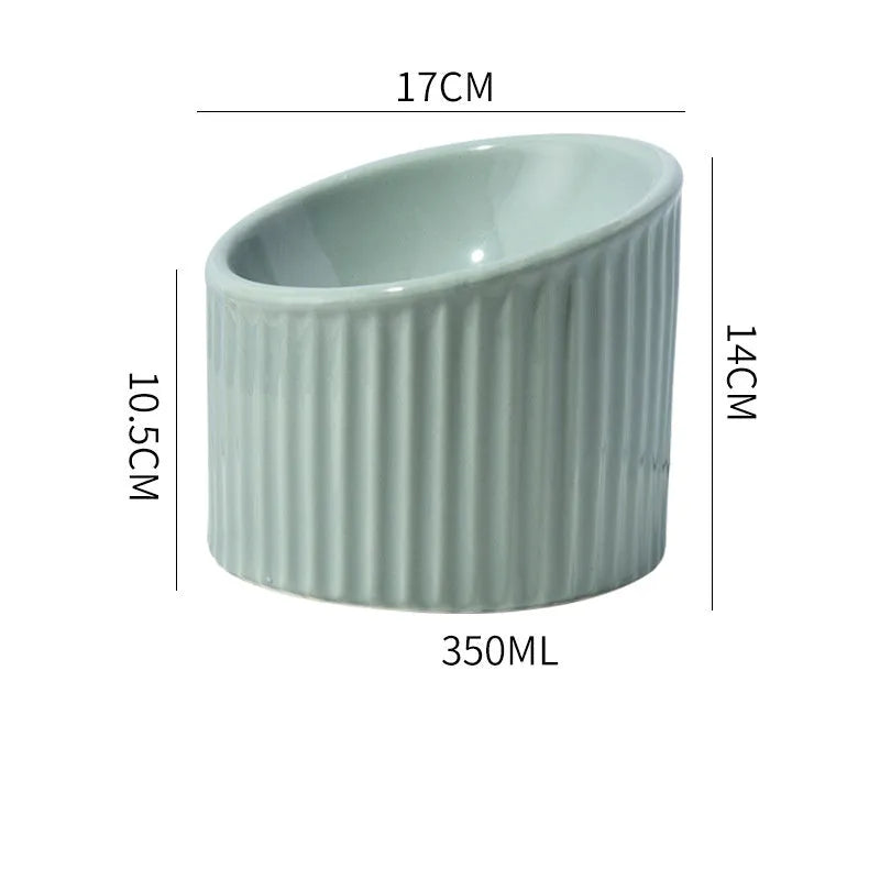 Elevated ceramic cat bowl in green, showing tilted design and raised height for feeding.