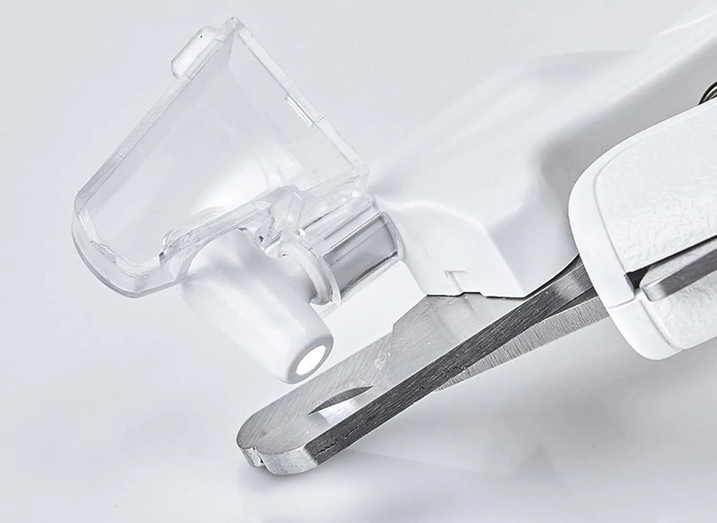 White pet nail clippers with LED light and a transparent anti-splash guard, shown with a nail file.