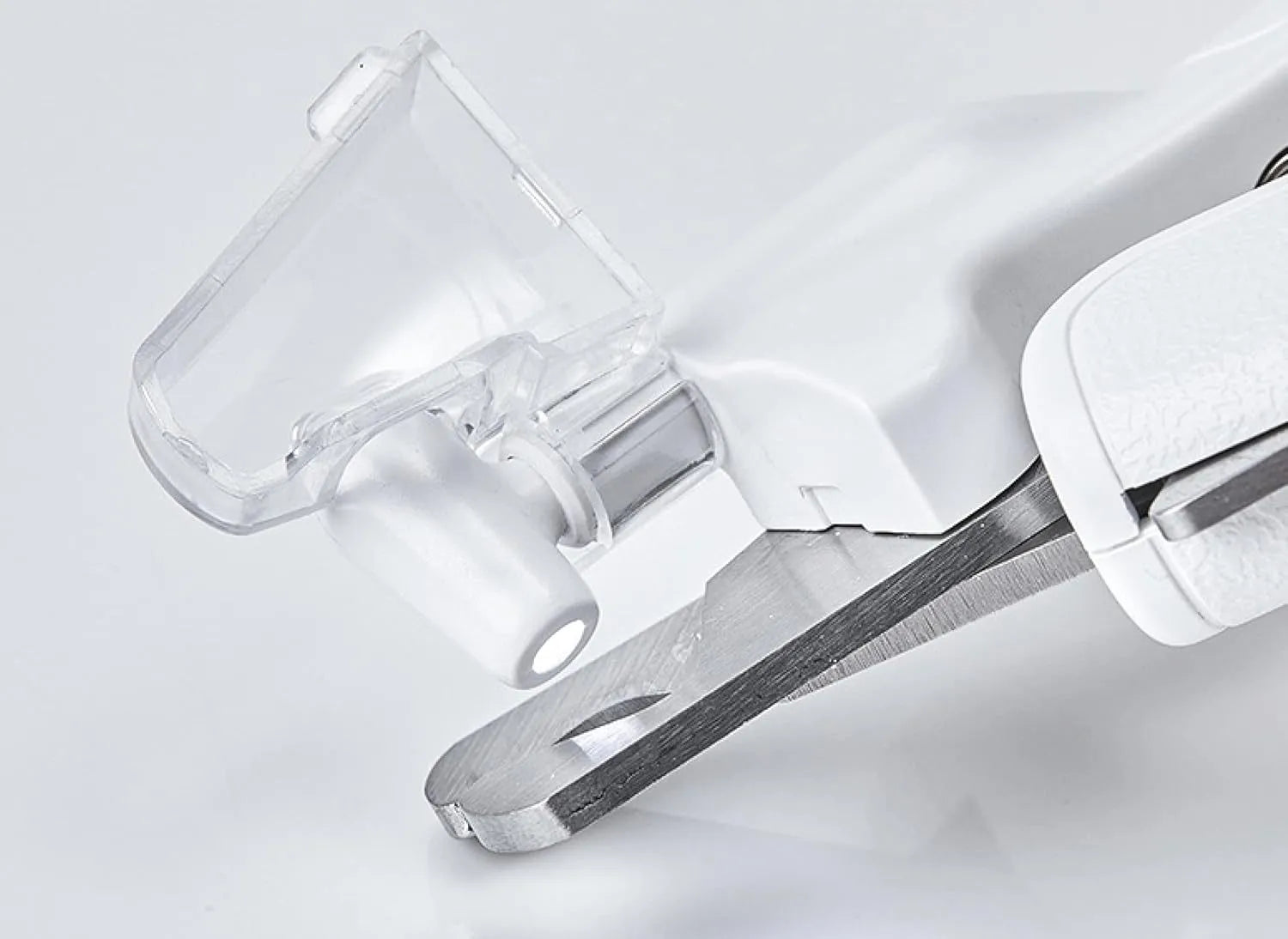 White pet nail clippers with LED light and a transparent anti-splash guard, shown with a nail file.