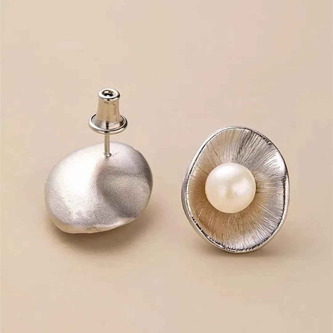 Sterling silver earrings with geometric design and cultured pearl accents on needle back fittings