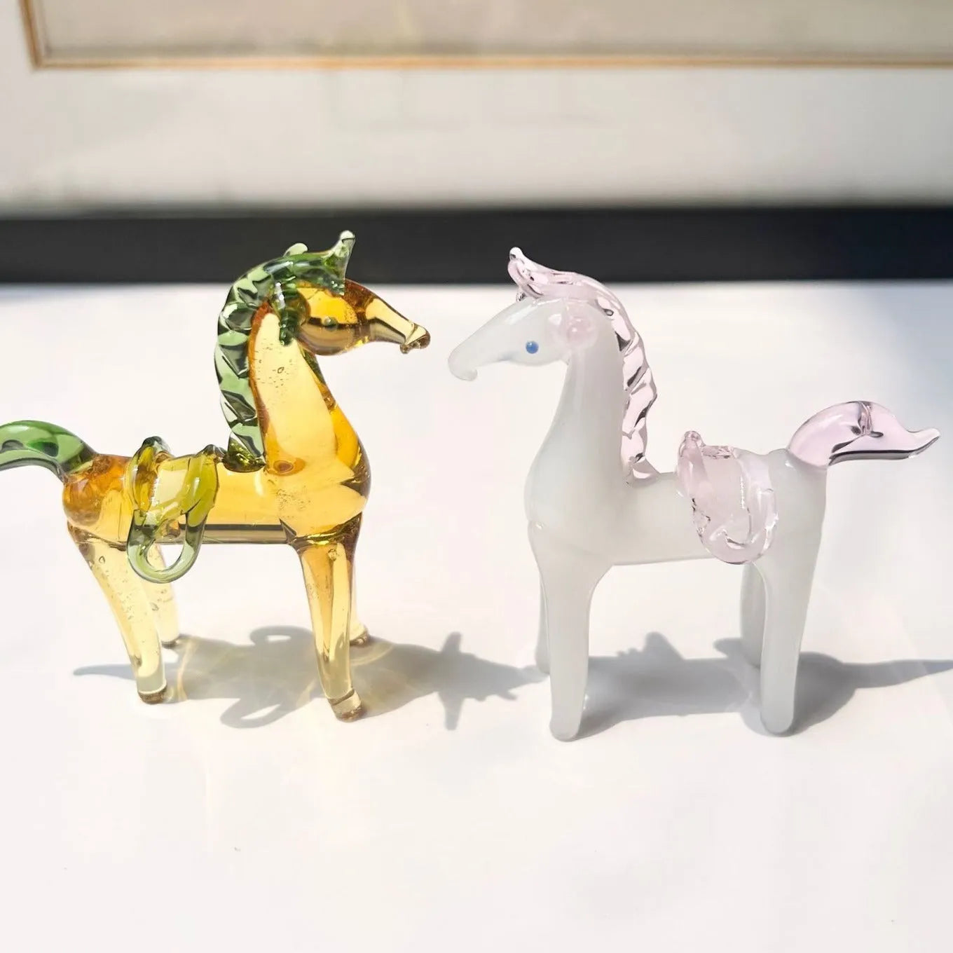 Brown glazed ceramic horse ornament on wooden shelf