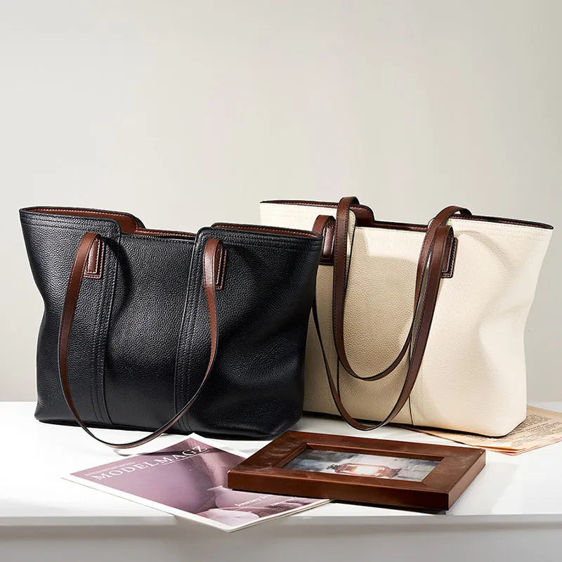 Women's black genuine leather crossbody bag with internal organiser compartments showing document and phone sections