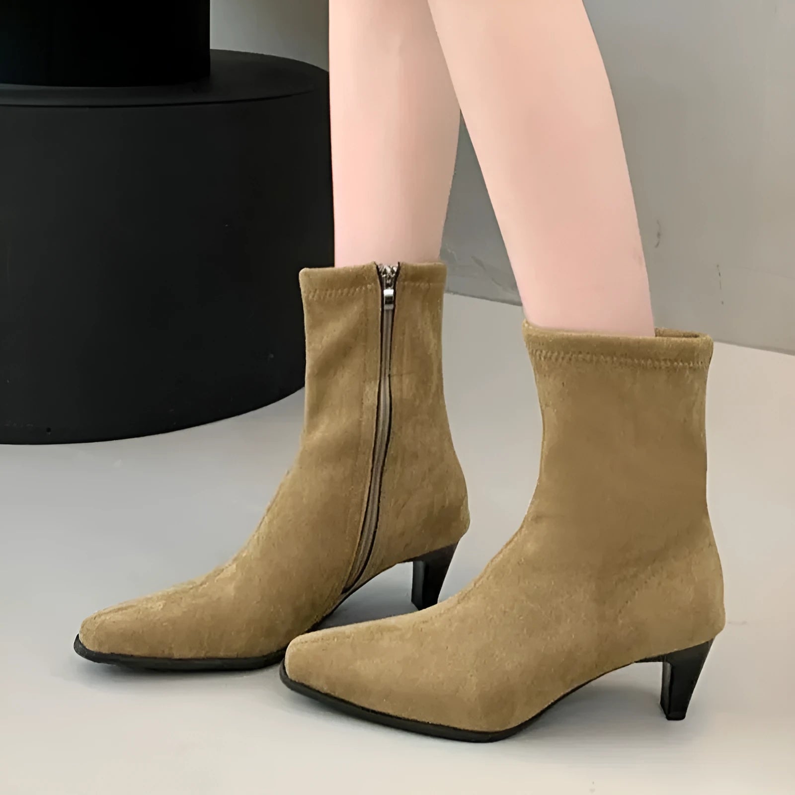 Brown square toe mid-calf boots with a side zipper and pointed stiletto kitten heel on a white background.