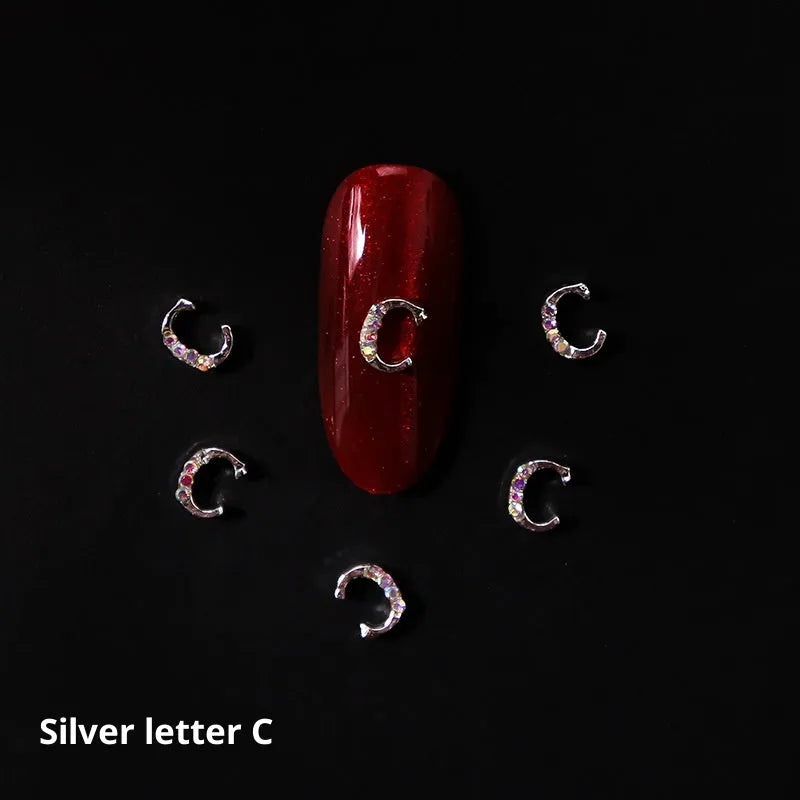 Gold alloy letter A nail ornament charm with crystal detail on a square chain base